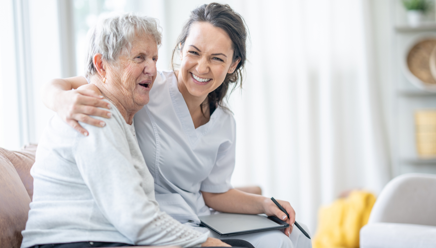 Carer in uniform supporting an older person at home