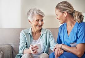 Support worker checking in with an older adult at home