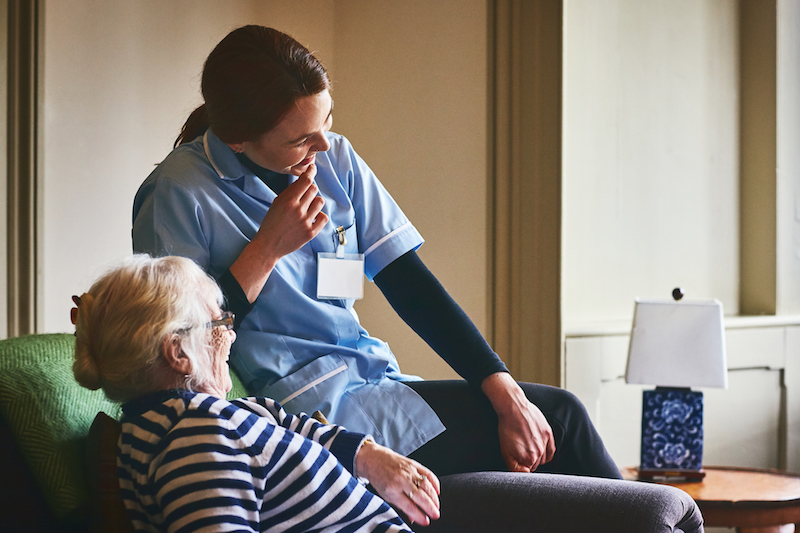 Support worker discussing a care plan with an older adult at home