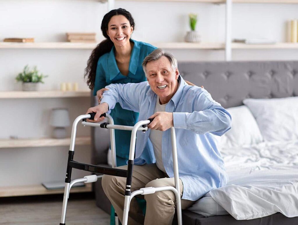 Carer helping an older person settle comfortably at home